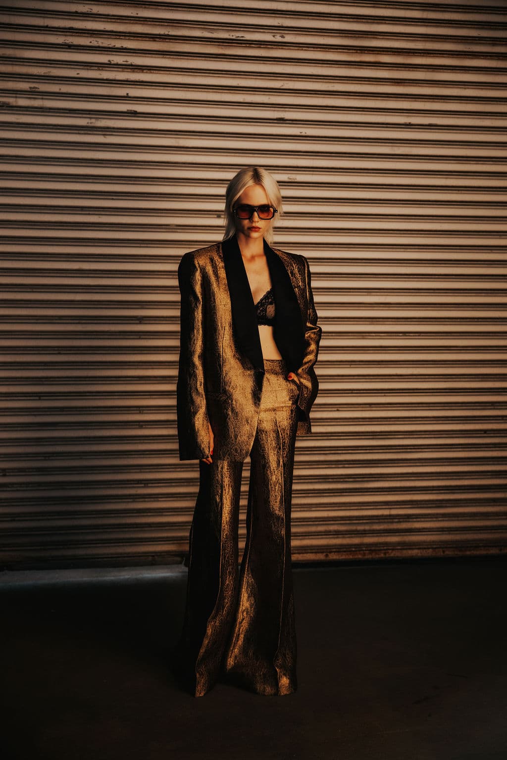 Full-length portrait of a model in bronze tailoring.