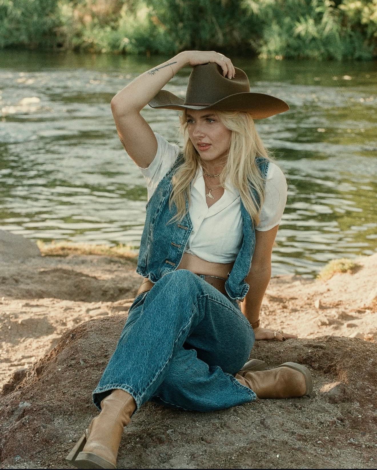Portrait of Hannah Warren beside a river.
