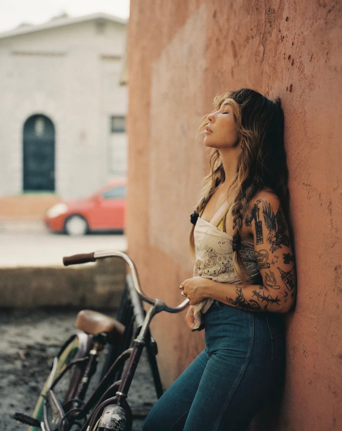 Film portrait of a woman beside a bicycle, photographed by Hannah Warren.