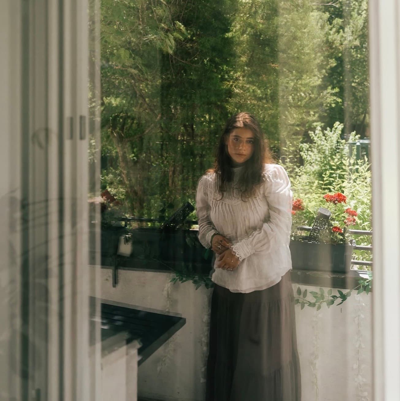 Portrait of Leonie Buchegger in a sunlit garden.