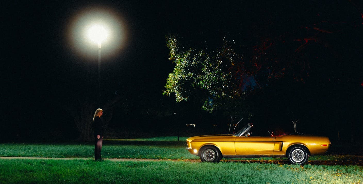 Sara Schultz beside a car.