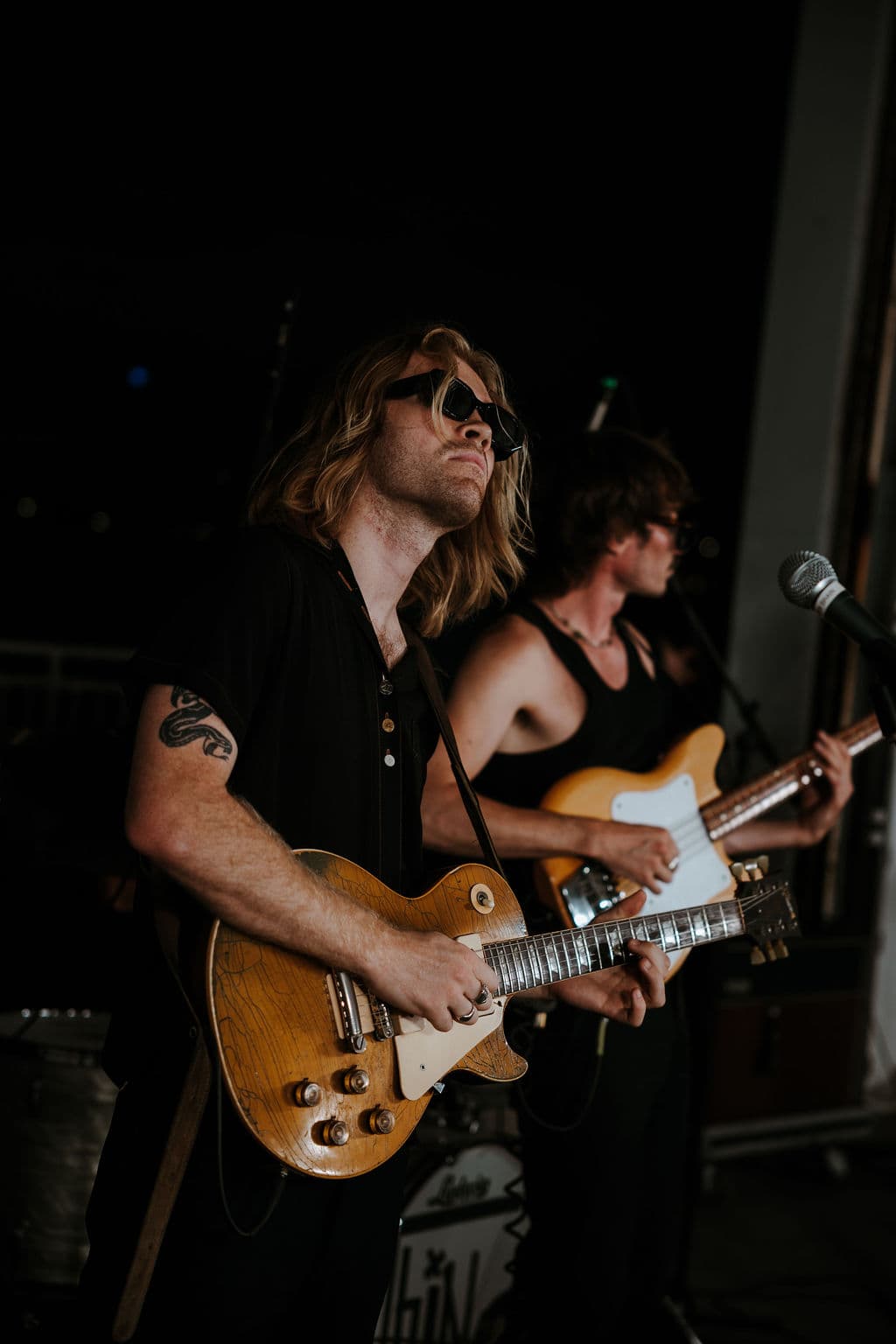 Two guitarists performing live during the Cucculelli Shaheen SS26 show.
