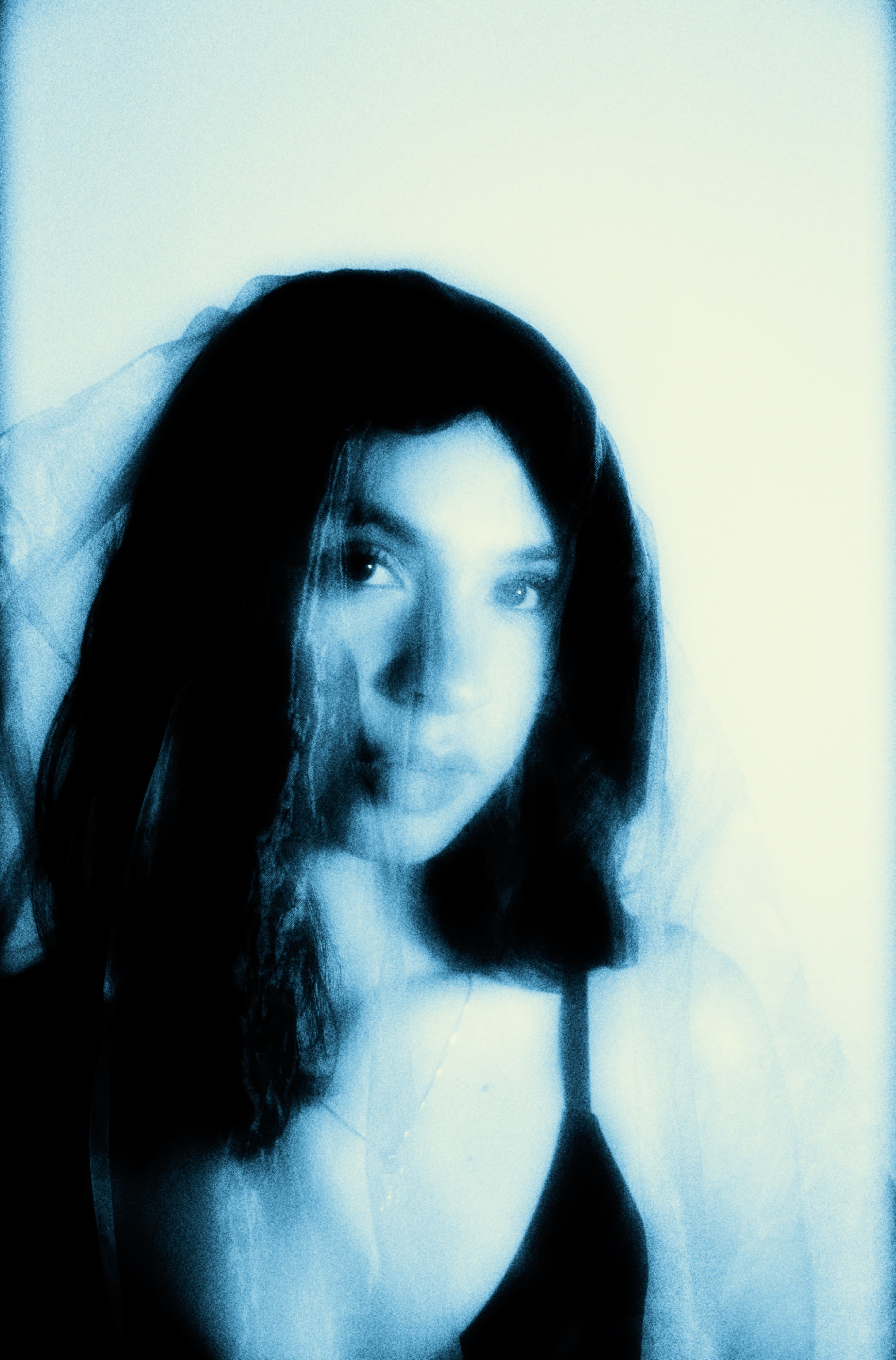 Blue-toned close portrait of Alyssa Banuelos.